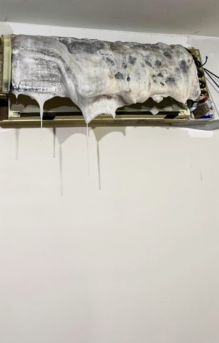 Chemical wash foam covering an aircon unit during cleaning